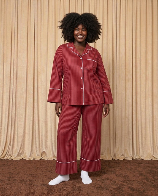 Woman wearing red and burgundy cotton striped pyjamas.