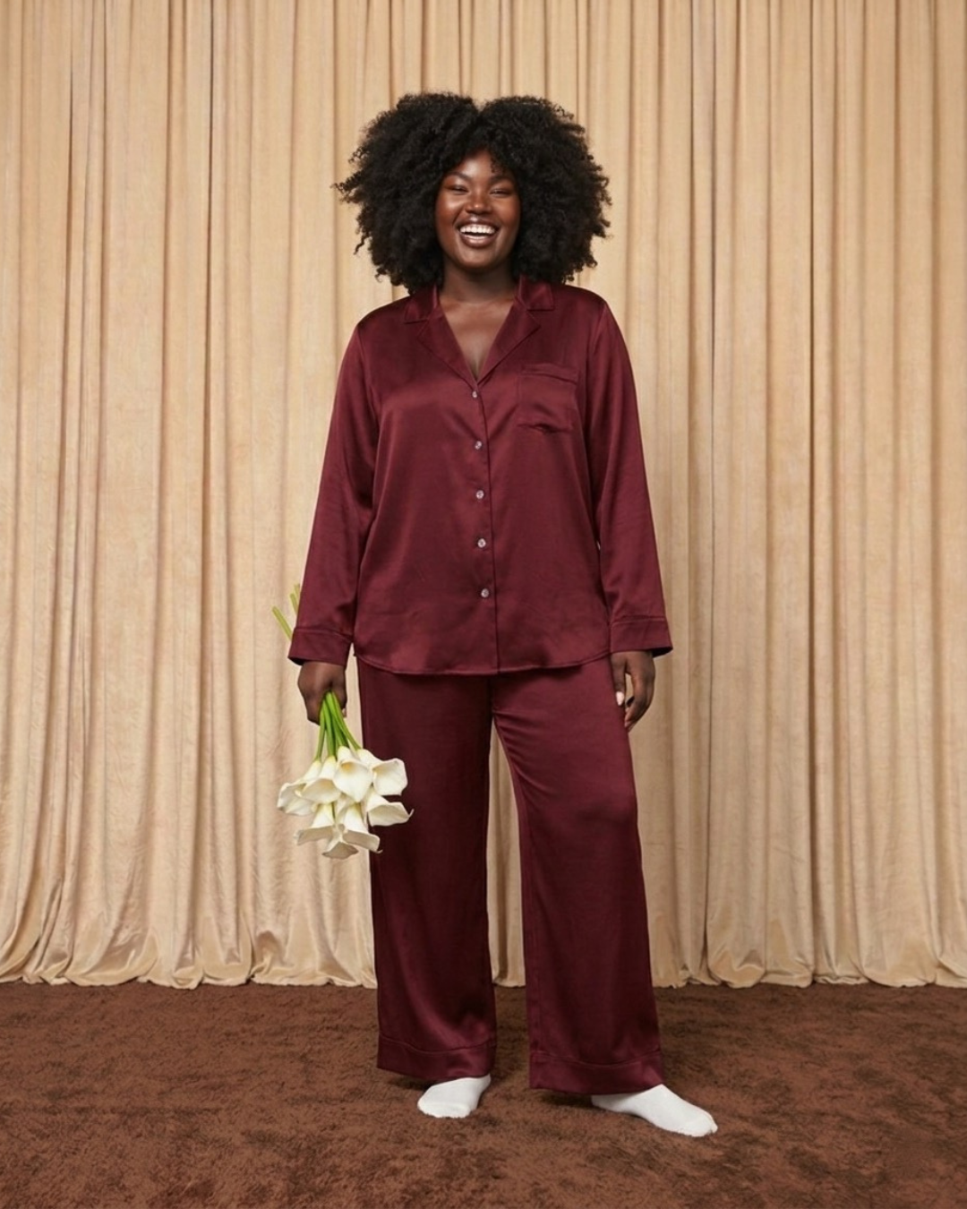 Model wearing burgundy silk pyjama set