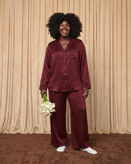 Model wearing burgundy silk pyjama set