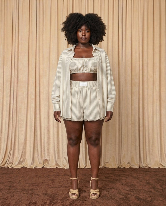 Woman wearing a three-piece bubble short set in sage green and matcha stripes 