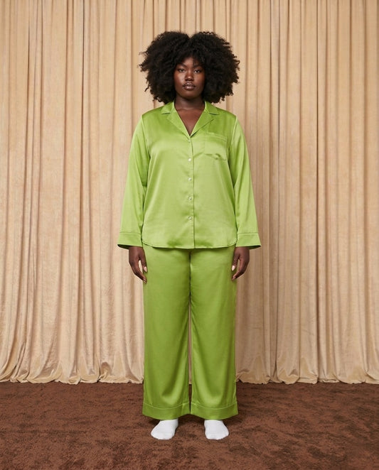 Woman wearing a leaf green silk pyjama set.